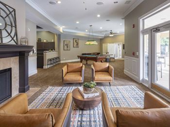 A living room with a fireplace and a pool table.